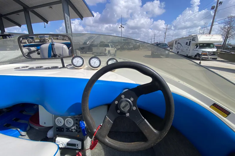 Slide: The Image of Interior view of a 1997 Malibu Tantrum boat with steering wheel and gauges. - 15