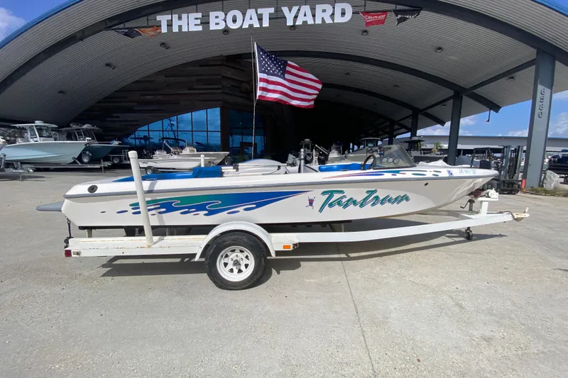 Slide: The Image of 1997 Malibu Tantrum boat on trailer at The Boat Yard, American flag displayed. - 3