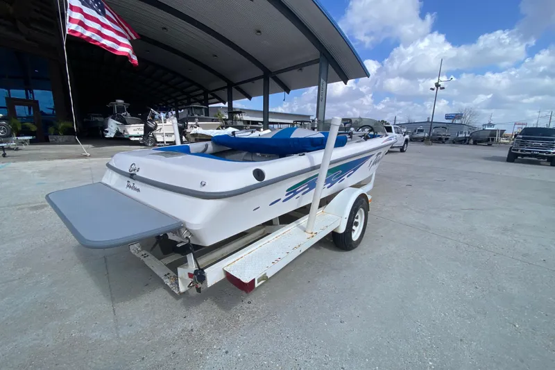 Slide: The Image of 1997 Malibu Tantrum boat on trailer, parked outdoors under a clear sky. - 4