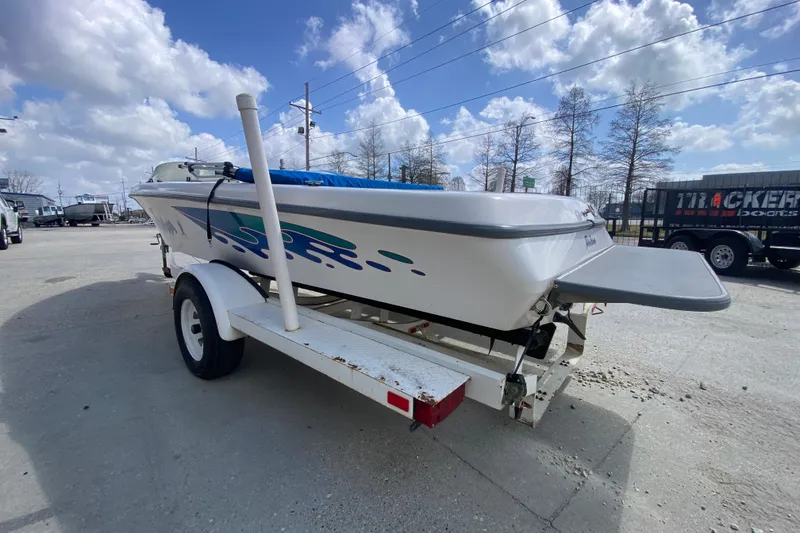 Slide: The Image of 1997 Malibu Tantrum boat on trailer under a partly cloudy sky. - 6