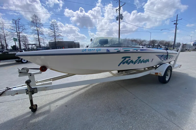 Slide: The Image of 1997 Malibu Tantrum boat on trailer under a partly cloudy sky. - 8