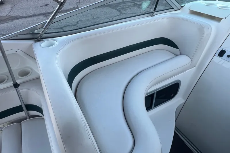 Slide: The Image of 2001 Chaparral Signature 260 boat interior with white seating and cup holders. - 15