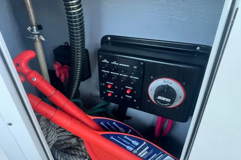 Slide: The Image of 2001 Chaparral Signature 260 boat electrical panel with emergency tools and ropes. - 17