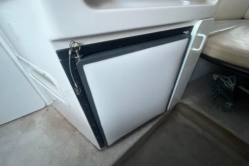 Slide: The Image of 2001 Chaparral Signature 260 interior with compact refrigerator and seating area. - 19