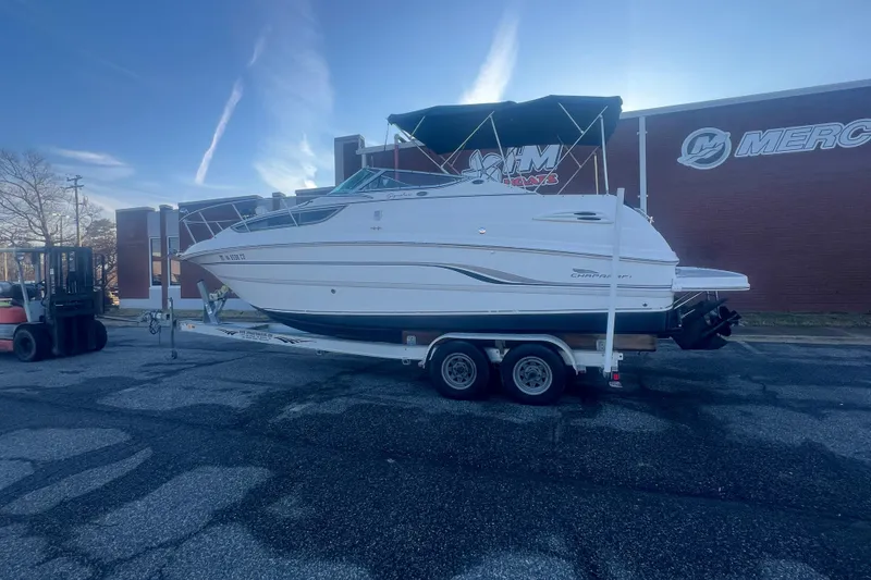 Slide: The Image of 2001 Chaparral Signature 260 boat on trailer outside a building. - 2