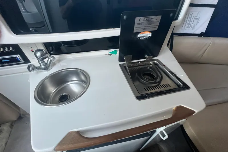Slide: The Image of 2001 Chaparral Signature 260 boat kitchenette with sink and stove. - 20