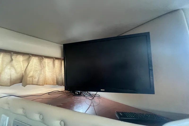 Slide: The Image of RCA TV and remote inside 2001 Chaparral Signature 260 boat cabin. - 23