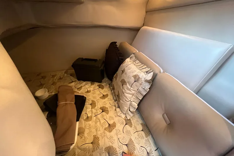 Slide: The Image of Interior cabin of 2001 Chaparral Signature 260 with cushions and patterned bedding. - 26