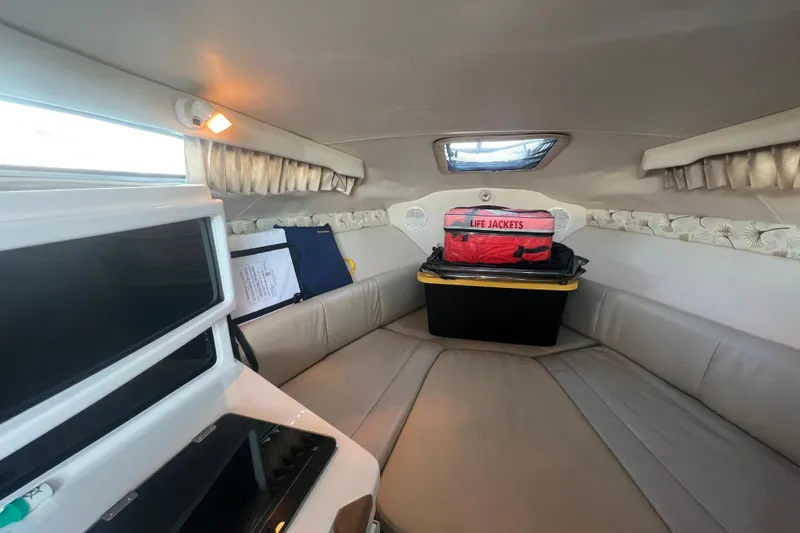 Slide: The Image of 2001 Chaparral Signature 260 cabin interior with seating, life jackets, and storage. - 27
