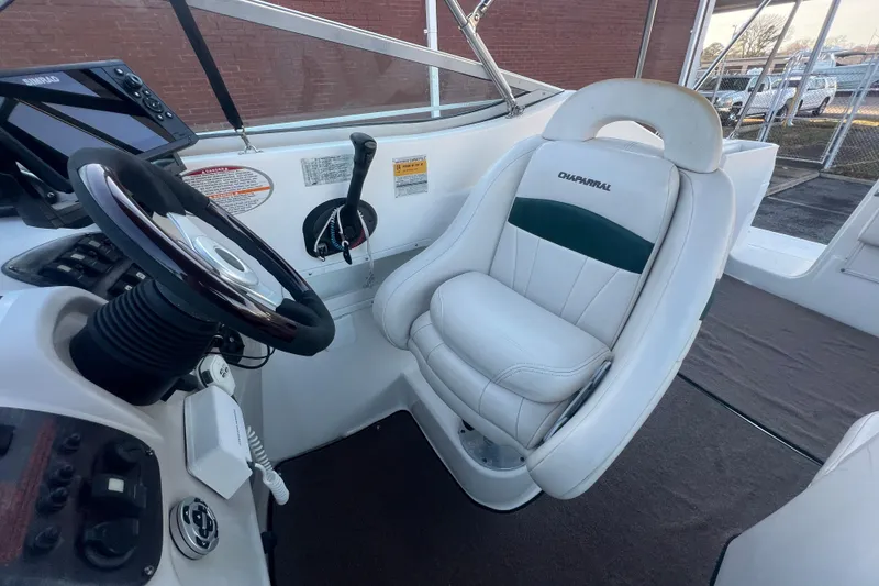 Slide: The Image of 2001 Chaparral Signature 260 boat cockpit with steering wheel and captain's chair. - 28
