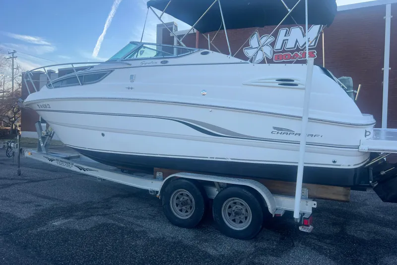Slide: The Image of 2001 Chaparral Signature 260 boat on trailer, parked outdoors near a building. - 3