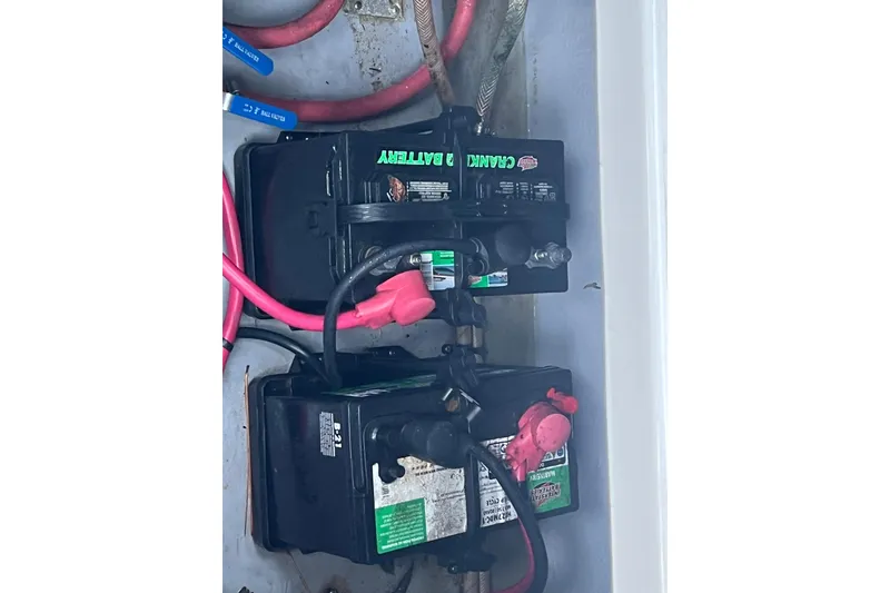 Slide: The Image of Battery compartment of a 2001 Chaparral Signature 260 boat with connected cables. - 32