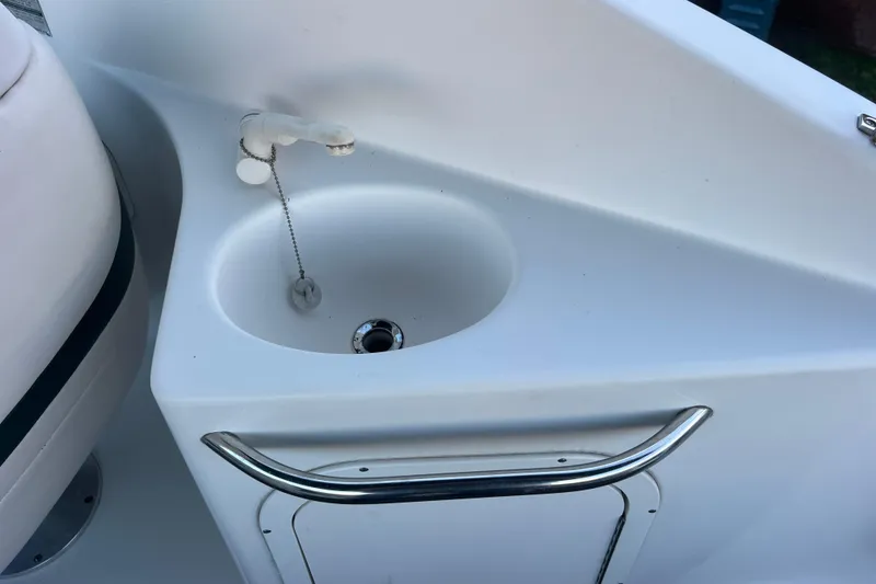 Slide: The Image of 2001 Chaparral Signature 260 boat sink with faucet and storage compartment. - 36