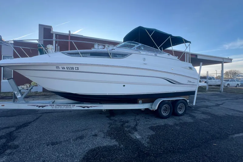 Slide: The Image of 2001 Chaparral Signature 260 boat on trailer, parked outdoors. - 42