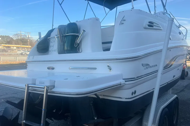 Slide: The Image of 2001 Chaparral Signature 260 boat on trailer, rear view with swim platform and ladder. - 7