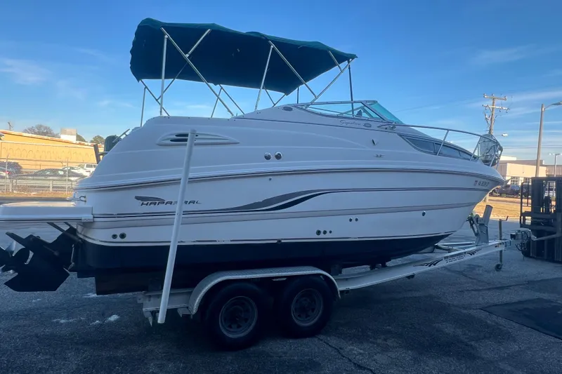 Slide: The Image of 2001 Chaparral Signature 260 boat on trailer with blue canopy, parked outdoors. - 8