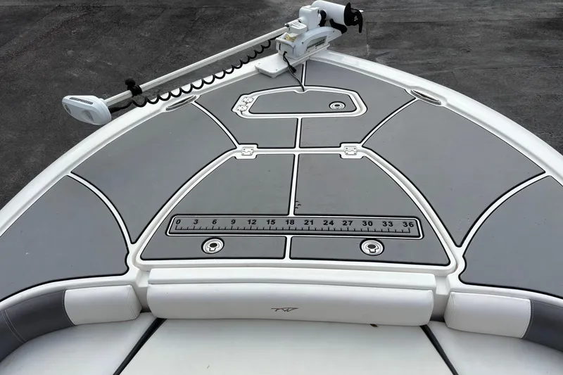 Slide: The Image of 2018 Tidewater 2500 Carolina Bay boat deck with measurement ruler and trolling motor. - 10
