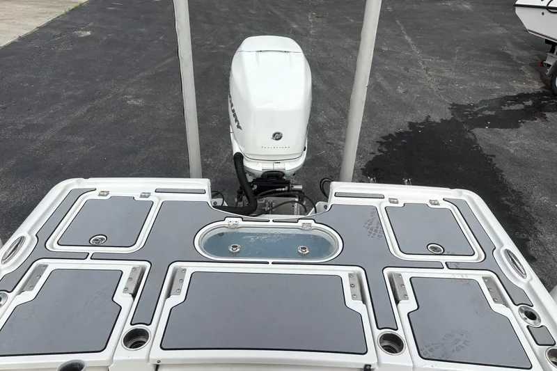 Slide: The Image of 2018 Tidewater 2500 Carolina Bay boat with Mercury outboard motor, featuring multiple storage compartments. - 12