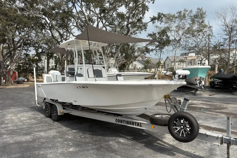 Slide: The Image of 2018 Tidewater 2500 Carolina Bay boat on trailer, parked outdoors. - 14