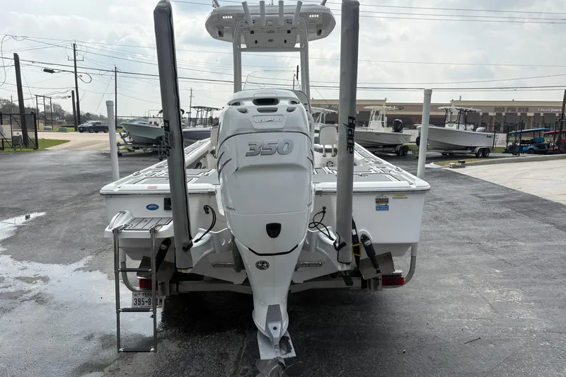 Slide: The Image of 2018 Tidewater 2500 Carolina Bay boat with powerful 350 engine, parked outdoors. - 4
