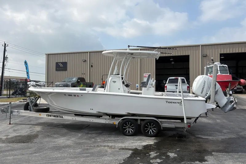 Slide: The Image of 2018 Tidewater 2500 Carolina Bay boat on trailer outside a warehouse. - 6