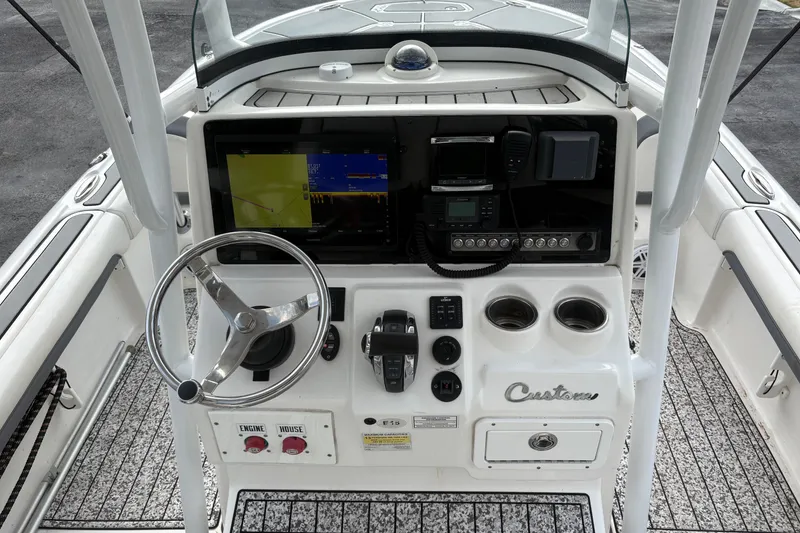 Slide: The Image of 2018 Tidewater 2500 Carolina Bay boat console with steering wheel and navigation equipment. - 8