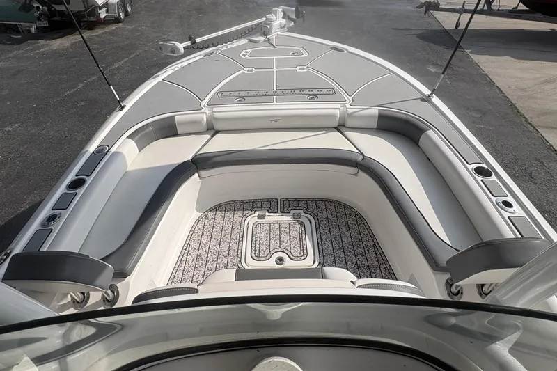 Slide: The Image of 2018 Tidewater 2500 Carolina Bay boat interior with cushioned seating and deck details. - 9