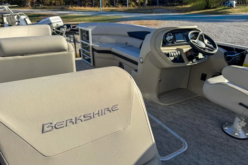 Slide: The Image of 2025 Berkshire 22CL LE pontoon boat interior with steering console and seating. - 7