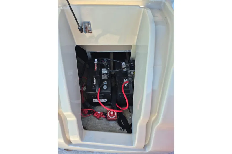 Slide: The Image of Battery compartment of 2017 Avalon 2785 boat with visible wiring and connections. - 14
