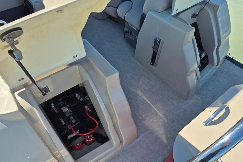 Slide: The Image of 2017 Avalon 2785 boat interior showing open storage compartments and battery setup. - 15