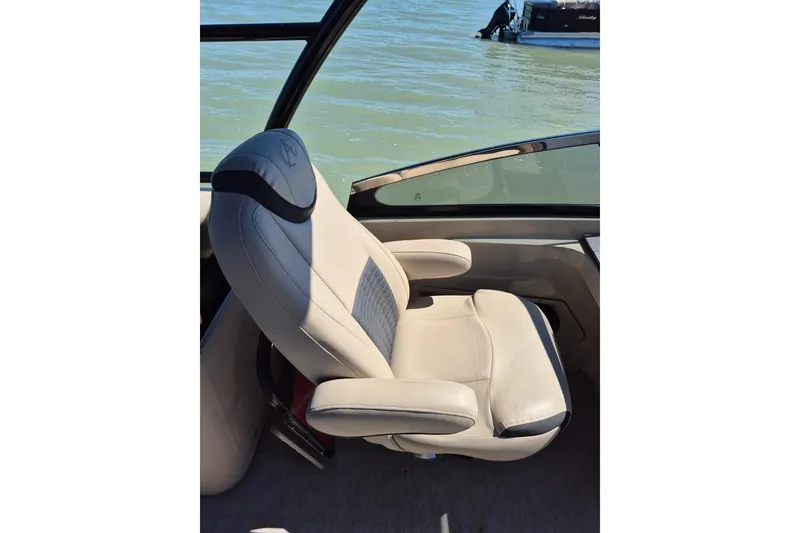 Slide: The Image of Luxurious beige captain's chair on 2017 Avalon 2785 boat, overlooking serene water. - 18