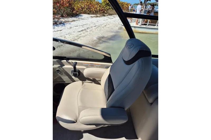 Slide: The Image of Captain's seat on 2017 Avalon 2785 boat, near sandy shore and water. - 19