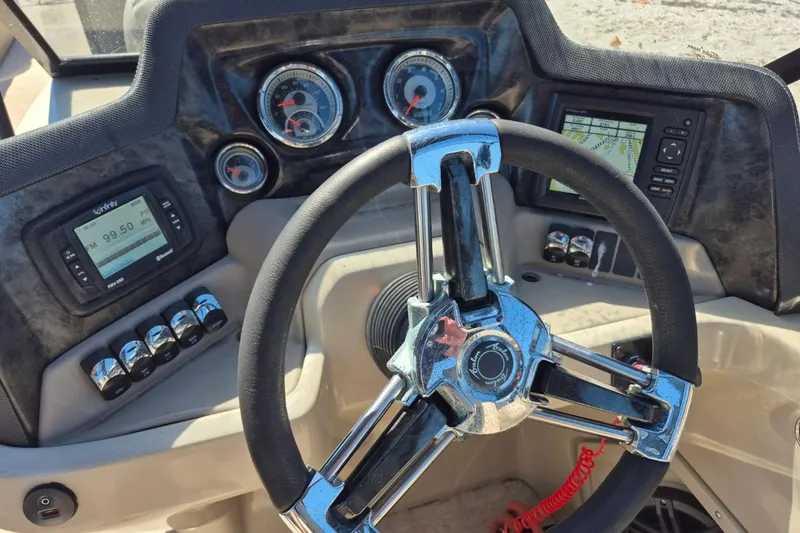 Slide: The Image of Steering console of a 2017 Avalon 2785 boat with gauges and controls. - 20