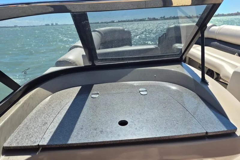 Slide: The Image of 2017 Avalon 2785 boat interior with windshield, on a sunny day at sea. - 23