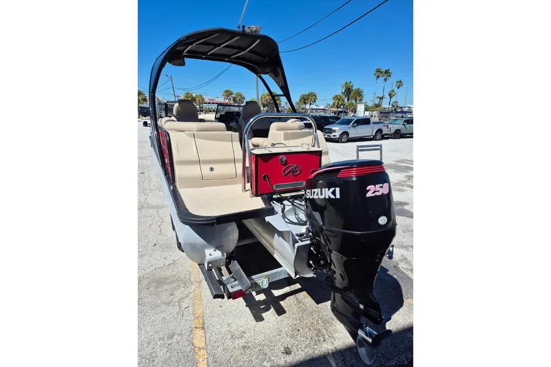 Slide: The Image of 2017 Avalon 2785 boat with Suzuki 250 outboard motor, parked outdoors. - 31