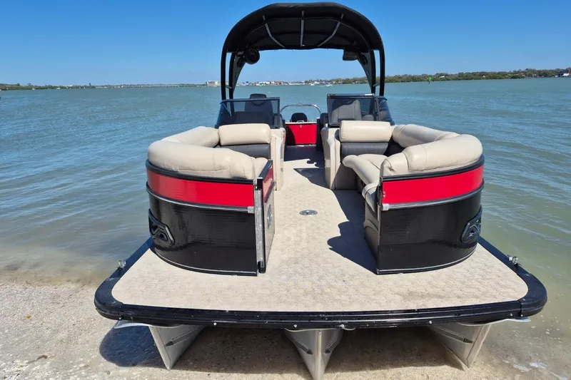 Slide: The Image of 2017 Avalon 2785 pontoon boat with beige seating, docked by the shore. - 4