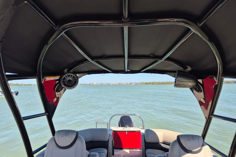 Slide: The Image of Interior view of a 2017 Avalon 2785 boat with seating and water backdrop. - 9