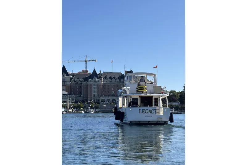 Slide: The Image of Ocean Alexander 50 Pilothouse yacht from 1981 on calm waters near historic buildings. - 2