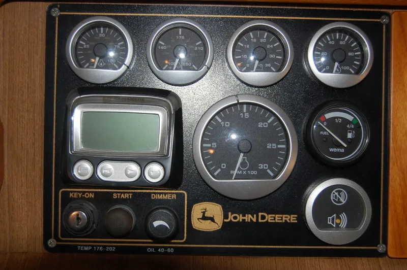 Slide: The Image of John Deere dashboard with gauges and controls. - 39