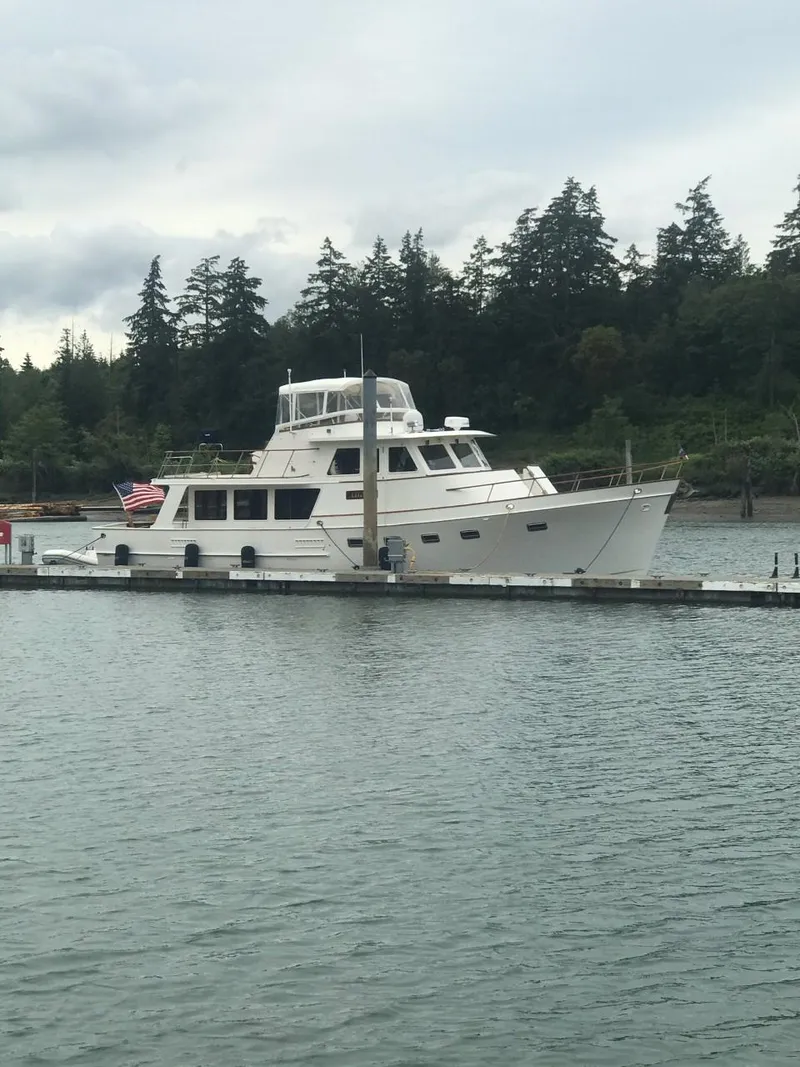 Slide: The Image of 1981 Ocean Alexander 50 Pilothouse docked with forested backdrop. - 6