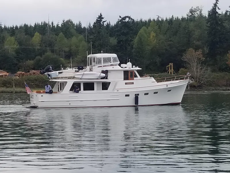 Slide: The Image of 1981 Ocean Alexander 50 Pilothouse on calm water near forest. - 7