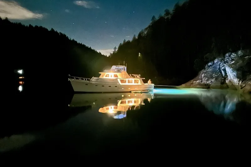 Slide: The Image of Ocean Alexander 50 Pilothouse yacht illuminated on calm water at night, 1981 model. - 8