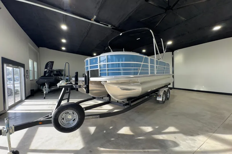 Slide: The Image of 2025 Berkshire 22RFC LE pontoon boat on trailer in showroom. - 10