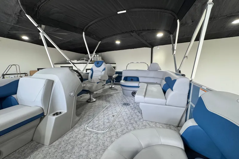 Slide: The Image of 2025 Berkshire 22RFC LE pontoon boat interior with modern seating and steering console. - 11