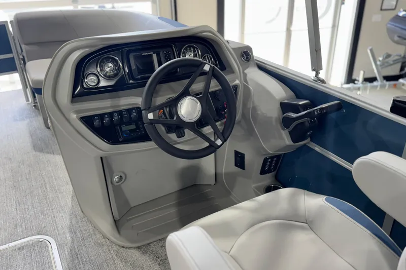 Slide: The Image of 2025 Berkshire 22RFC LE boat helm with steering wheel and control panel. - 15