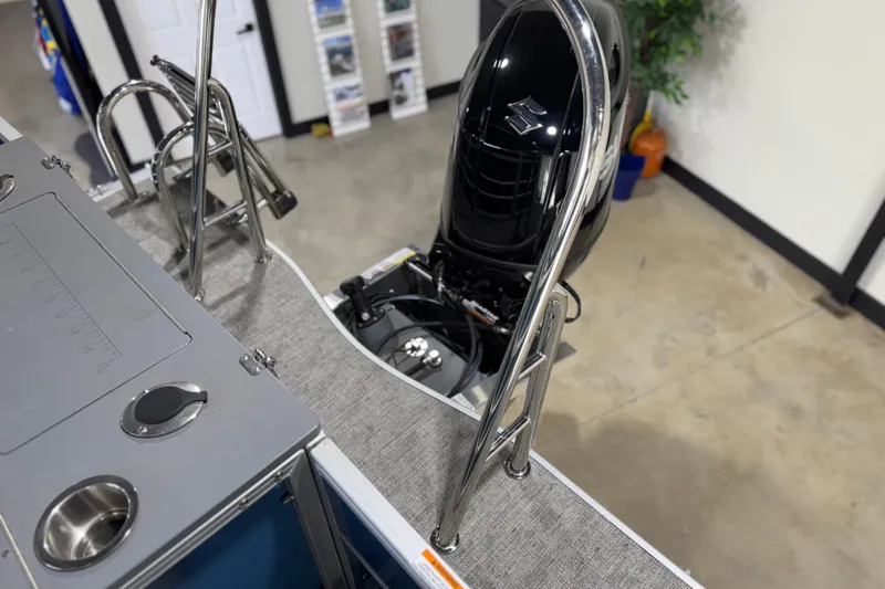 Slide: The Image of 2025 Berkshire 22RFC LE boat with stainless steel ladder and outboard motor in showroom. - 18