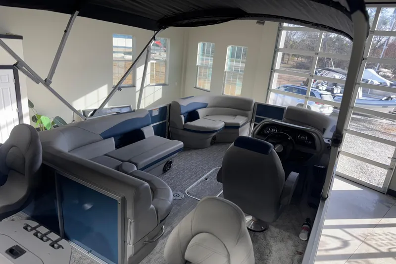 Slide: The Image of Interior of 2025 Berkshire 22RFC LE pontoon boat with plush seating and modern dashboard. - 20
