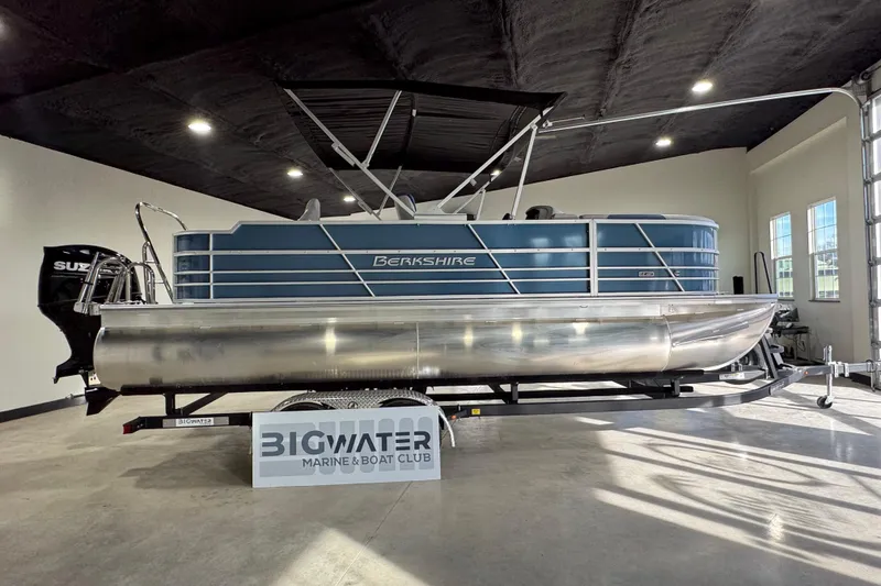 Slide: The Image of 2025 Berkshire 22RFC LE pontoon boat displayed indoors at Big Water Marine & Boat Club. - 6