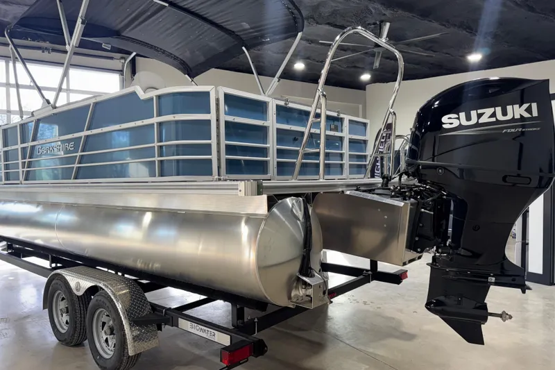 Slide: The Image of 2025 Berkshire 22RFC LE pontoon boat with Suzuki outboard motor on trailer. - 7