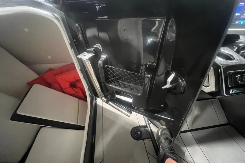 Slide: The Image of Interior view of a 2021 Yamaha Boats 255XD, featuring seating and storage compartment. - 26